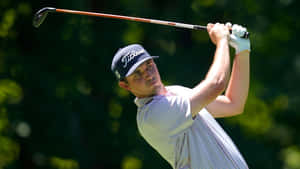 Champion Golfer Jt Poston At Swing Pinnacle With Golf Club Above His Head. Wallpaper