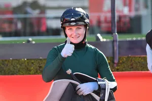 Champion Jockey Jamie Kah Riding A Horse Wallpaper