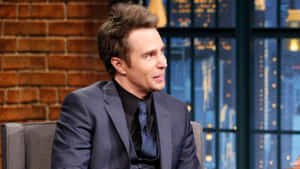 Charismatic Sam Rockwell On Late Night With Seth Meyers Wallpaper
