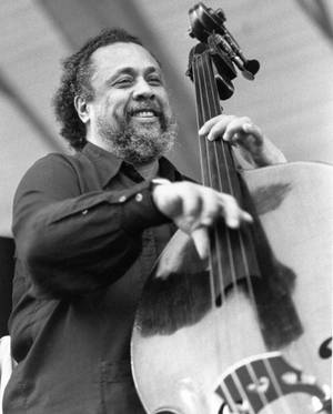 Charles Mingus Joyfully Playing Bass Guitar Wallpaper