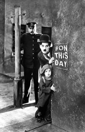 Charlie Chaplin Entertains A Young Fan. Wallpaper