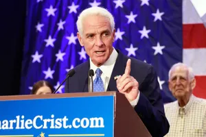 Charlie Crist Raising One Finger In Determination Wallpaper