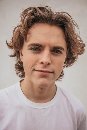 Charming Blonde Man Taking A Selfie In A White Shirt. Wallpaper