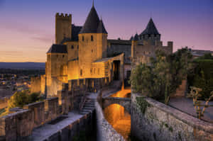 Chateau Comtal In Carcassonne During Nighttime Wallpaper