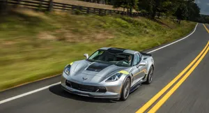 Chevrolet Corvette Grand Sport Cruising On An Open Road Wallpaper