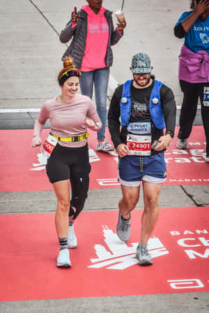 Chicago Marathon Runners Crossing Finish Line Wallpaper