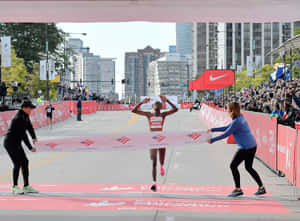 Chicago Marathon Winner Crossing Finish Line Wallpaper