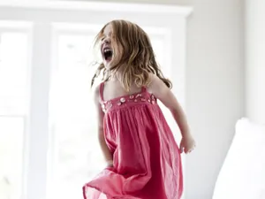 Child Jumpingon Bedin Excitement.jpg Wallpaper