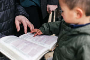 Child Learning From Book With Adult Wallpaper