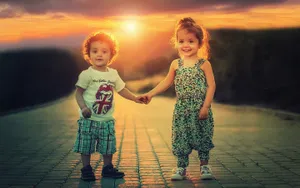 Children Holding Hands At Sunset Wallpaper
