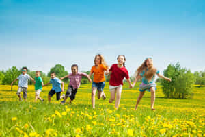 Children Runningin Fieldon Sunny Day Wallpaper