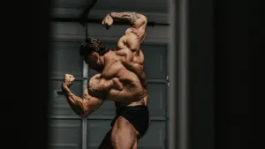 Chris Bumstead Flexing Back Muscles Wallpaper