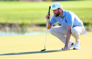 Chris Kirk Studying Golf Terrain Wallpaper