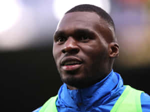 Christian Benteke Wearing Blue Raincoat Wallpaper