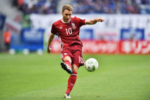 Christian Eriksen In Red Kicking The Ball Wallpaper
