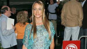 Christine Taylor Striking A Pose In A Beautiful Blue Dress Wallpaper