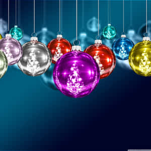 Christmas Ornaments Hanging From Strings On A Blue Background Wallpaper