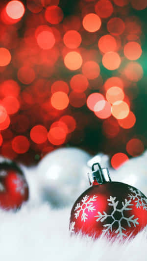 Christmas Ornaments On A White Background With Bokeh Lights Wallpaper