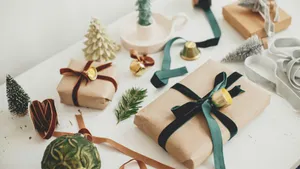 Christmas Presents On A Table With Green Ribbons Wallpaper