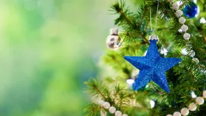 Christmas Tree With Blue Star Ornaments And Beads Wallpaper