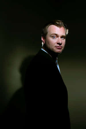 Christopher Nolan Posing For A Photoshoot Wallpaper