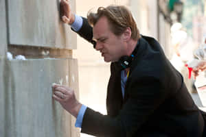 Christopher Nolan Standing With Celebrated Film Academy Awards Wallpaper