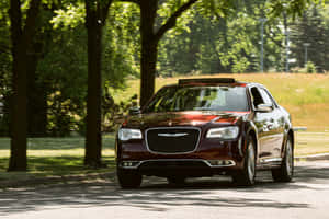 Chrysler 300 Driving Down An Open Road On A Sunny Day Wallpaper