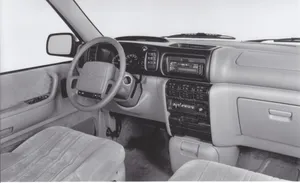 Chrysler Voyager Driving On A Scenic Road Wallpaper