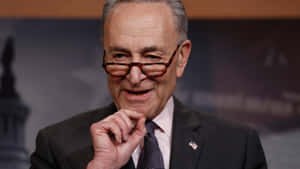 Chuck Schumer Smiling During Press Conference Wallpaper