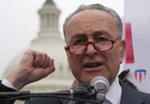 Chuck Schumer Speakingat Podium Wallpaper