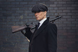 Cillian Murphy With Rifle Wallpaper