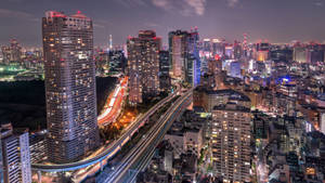 City Lights Illuminate Tokyo's Seaside Observatory At Night Wallpaper