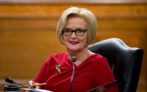 Claire Mccaskill Smiling In Red Dress Wallpaper