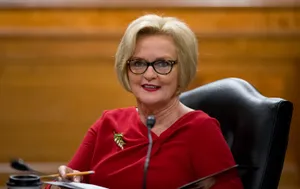 Claire Mccaskill Smiling In Red Dress Wallpaper