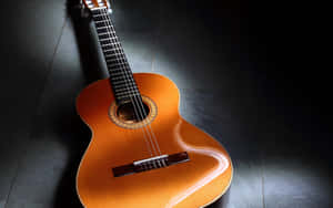 Classic Acoustic Guitaron Dark Background.jpg Wallpaper