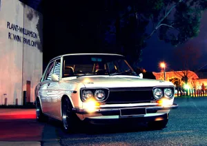 Classic Datsun 1600 Cruising On The Open Road Wallpaper