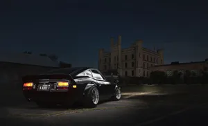 Classic Datsun Car In Vibrant Blue Wallpaper