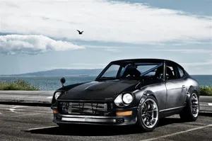 Classic Datsun Cruising Down The Road Wallpaper