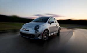 Classic Fiat 500 Cruising Down The Road Wallpaper