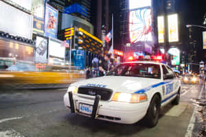 Classic Ford Crown Victoria On A Scenic Road Wallpaper