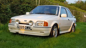 Classic Ford Escort Shining Under The Sun Wallpaper