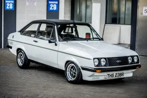 Classic Ford Escort Showcased At An Automobile Event Wallpaper