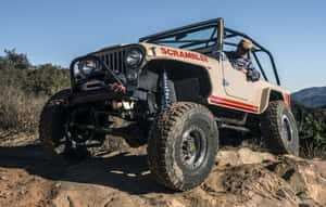 Classic Jeep Cj Conquering Off-road Terrain Wallpaper