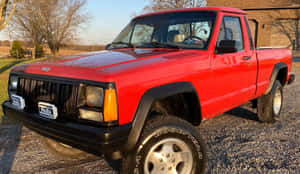 Classic Jeep Comanche Standing Proudly In Wilderness Wallpaper