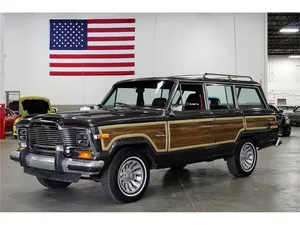 Classic Jeep Wagoneer On A Mountain Trail Wallpaper