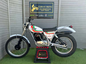 Classic Ossa Motorcycle In Spotlight Wallpaper