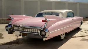 Classic Pink Cadillac On An Open Road Wallpaper