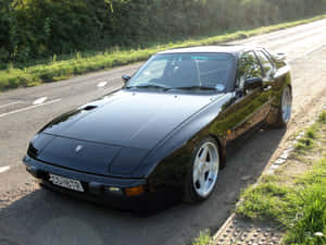 Classic Porsche 944 On An Open Road Wallpaper