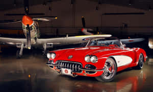 Classic Red Chevrolet Corvette C1 On Route Wallpaper