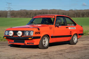 Classic Red Ford Escort On The Road Wallpaper